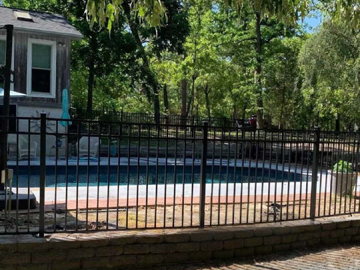 No-dig aluminum pool fence installation by Dynamic Fence Company in Fayetteville NC, securing a residential backyard pool with durable, code-compliant safety fencing.